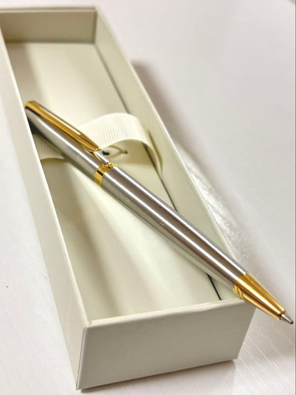 Waterman ballpoint pen with silver body and gold trim on a white background