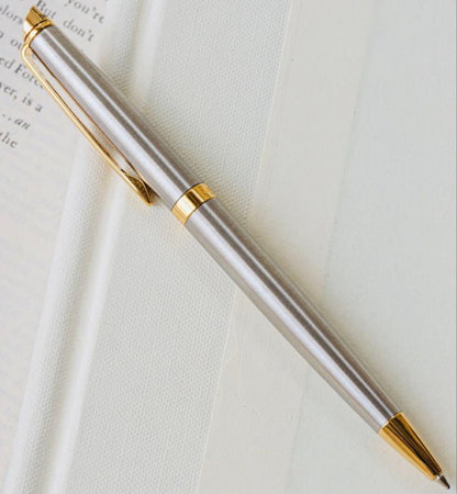 Waterman ballpoint pen with silver body and gold trim on a white background