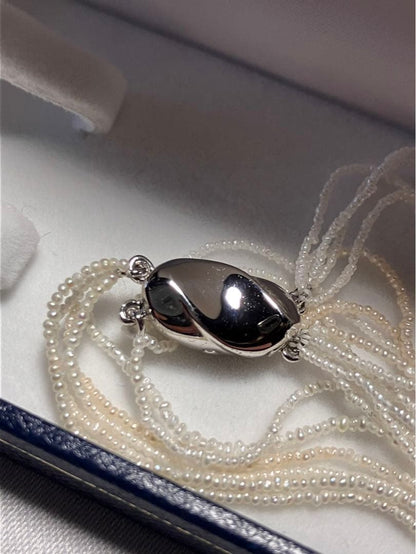 Akoya pearl 10-strand long necklace with small Keshi pearls and k18 white gold mirror-cut balls