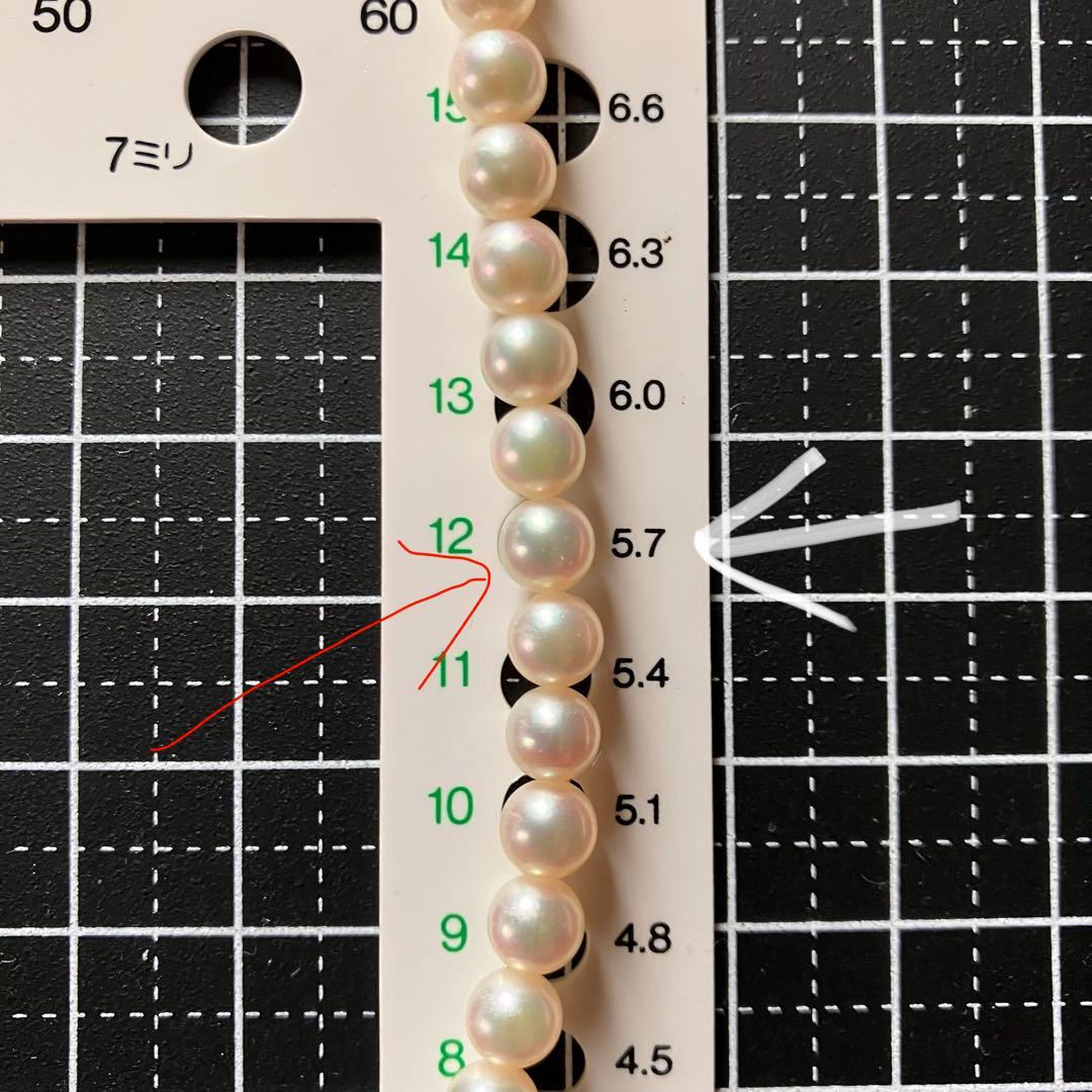 MIKIMOTO pearl choker necklace with 63 round pearls and silver M engraved clasp displayed with original box
