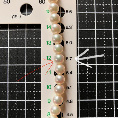 MIKIMOTO pearl choker necklace with 63 round pearls and silver M engraved clasp displayed with original box