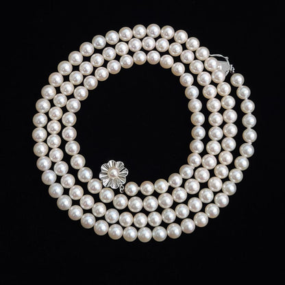 Akoya pearl long necklace with 6mm pearls measuring 80cm in length on a white background