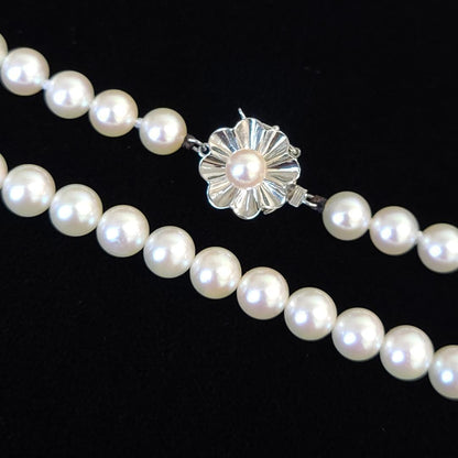 Akoya pearl long necklace with 6mm pearls measuring 80cm in length on a white background