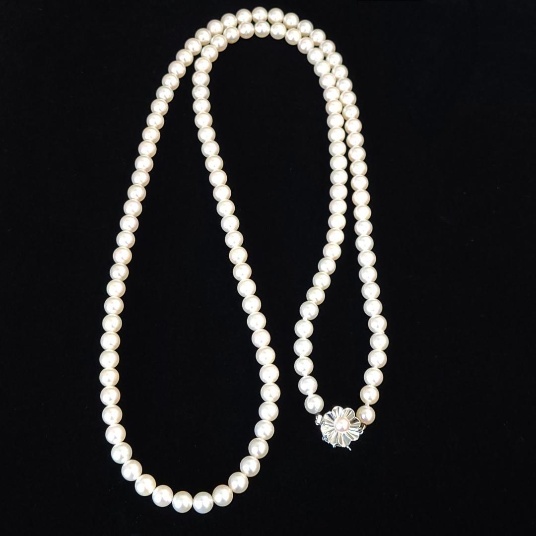 Akoya pearl long necklace with 6mm pearls measuring 80cm in length on a white background
