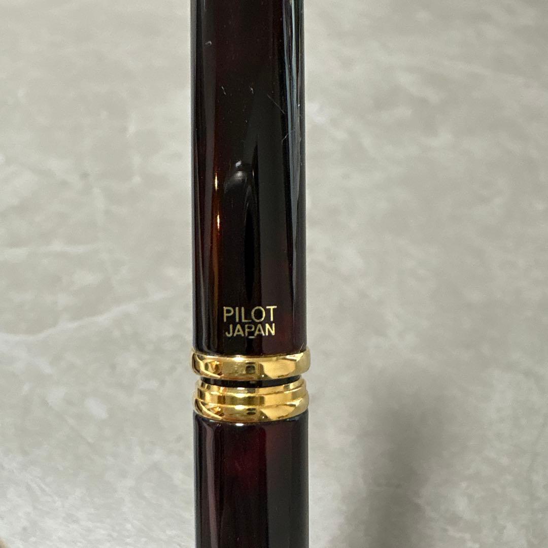 Pilot Cavalier fountain pen in dark brown with gold trim and capped nib on white background