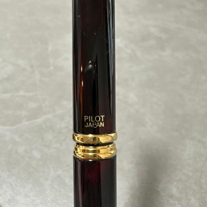 Pilot Cavalier fountain pen in dark brown with gold trim and capped nib on white background