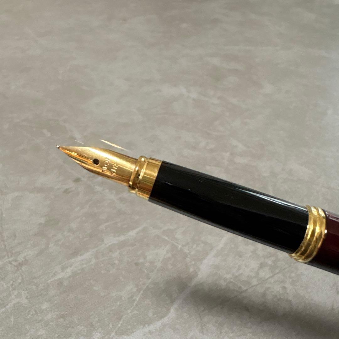 Pilot Cavalier fountain pen in dark brown with gold trim and capped nib on white background