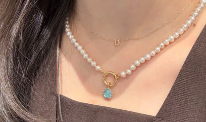Agete pearl necklace featuring lustrous freshwater pearls displayed with gift box and guarantee card