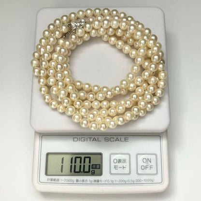 Two-strand long white Akoya pearl necklace with 7.5mm pearls on a white background