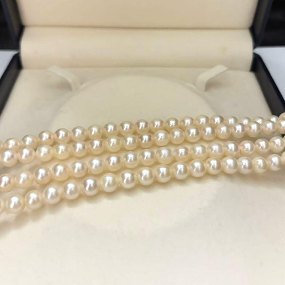 Two-strand long white Akoya pearl necklace with 7.5mm pearls on a white background