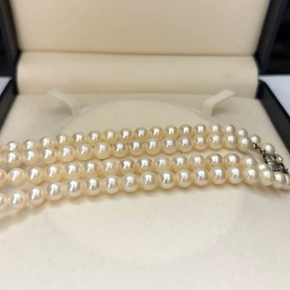 Two-strand long white Akoya pearl necklace with 7.5mm pearls on a white background