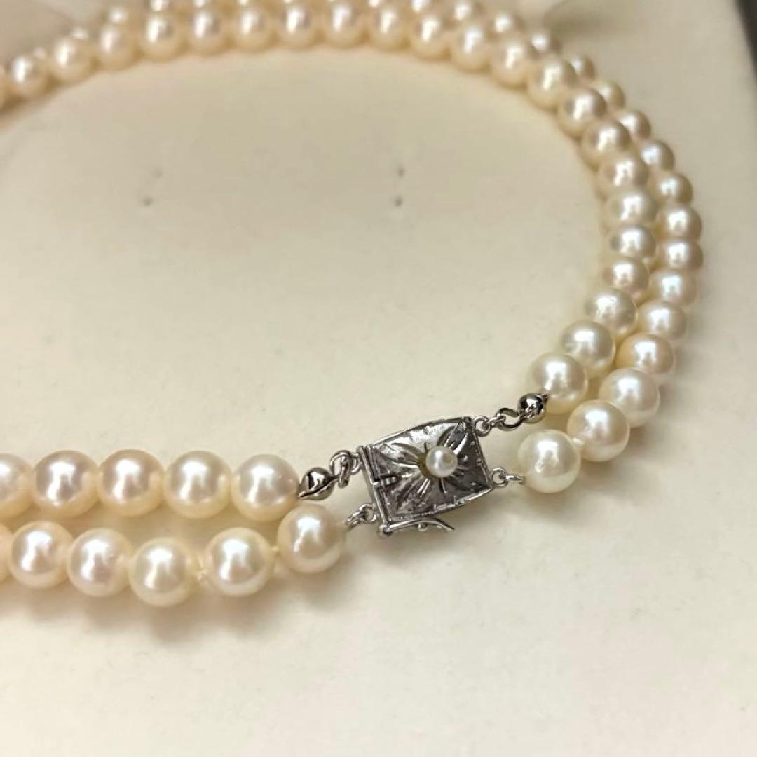 Two-strand long white Akoya pearl necklace with 7.5mm pearls on a white background