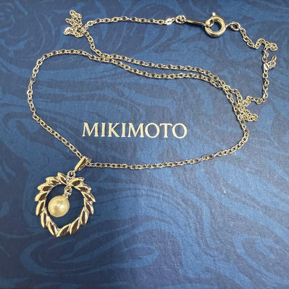 Mikimoto silver pearl necklace with 37.5 cm length displayed on white background