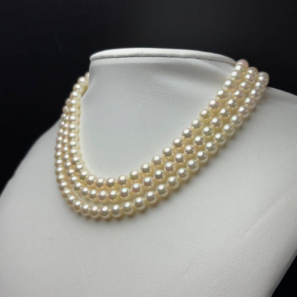 MIKIMOTO Akoya pearl necklace with 6.0-6.5mm white pearls and silver clasp on white background