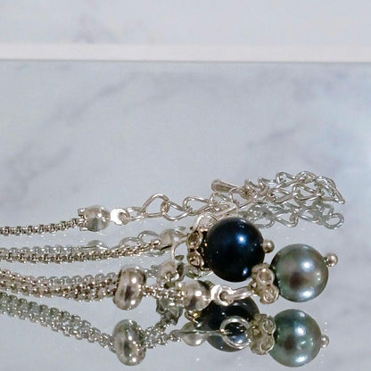 Akoya pearl necklace with slightly round pearls and silver nickel-free clasp on white background