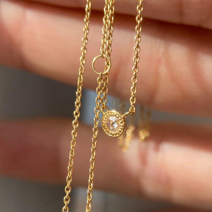 AGETE K18 yellow gold necklace with 0.03 ct rose cut diamond and milgrain detailing on a delicate chain