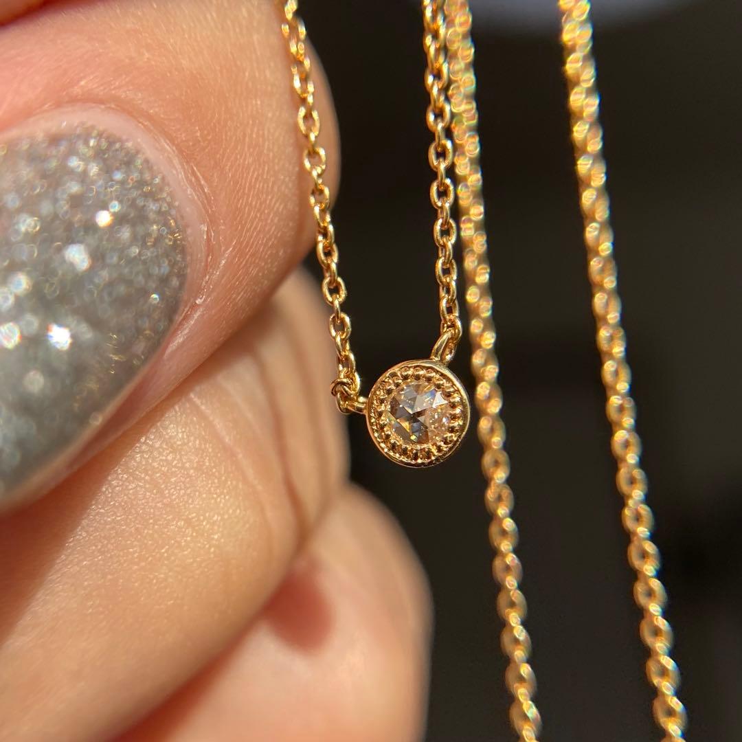 AGETE K18 yellow gold necklace with 0.03 ct rose cut diamond and milgrain detailing on a delicate chain