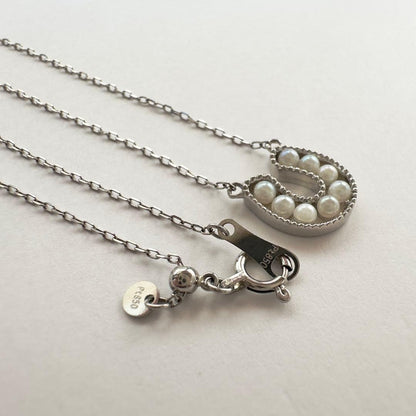 PT900 Akoya Pearl Horseshoe Pendant featuring 8 pearls on a PT850 chain with slide clasp