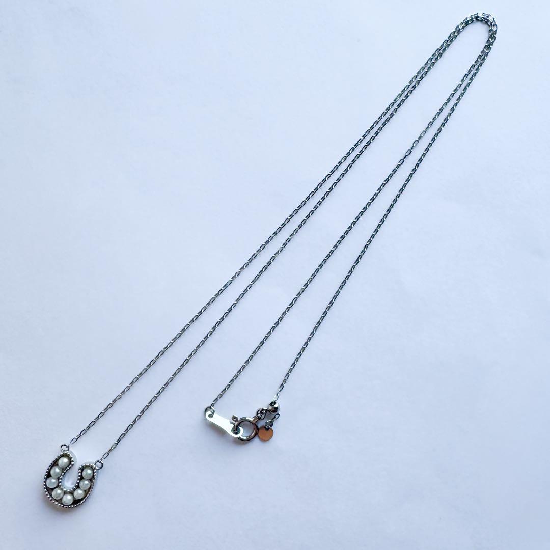 PT900 Akoya Pearl Horseshoe Pendant featuring 8 pearls on a PT850 chain with slide clasp