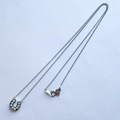 PT900 Akoya Pearl Horseshoe Pendant featuring 8 pearls on a PT850 chain with slide clasp