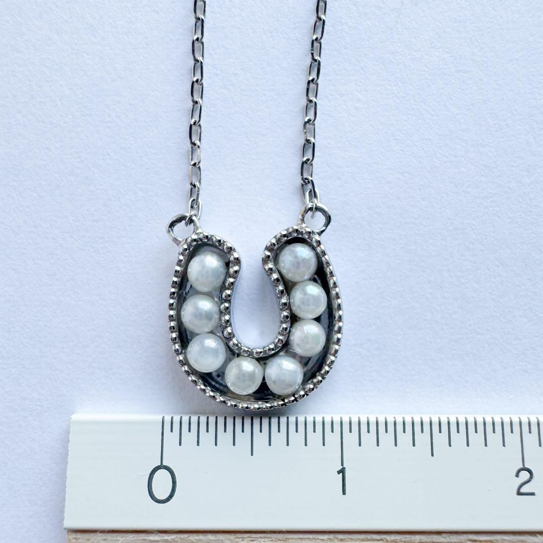 PT900 Akoya Pearl Horseshoe Pendant featuring 8 pearls on a PT850 chain with slide clasp