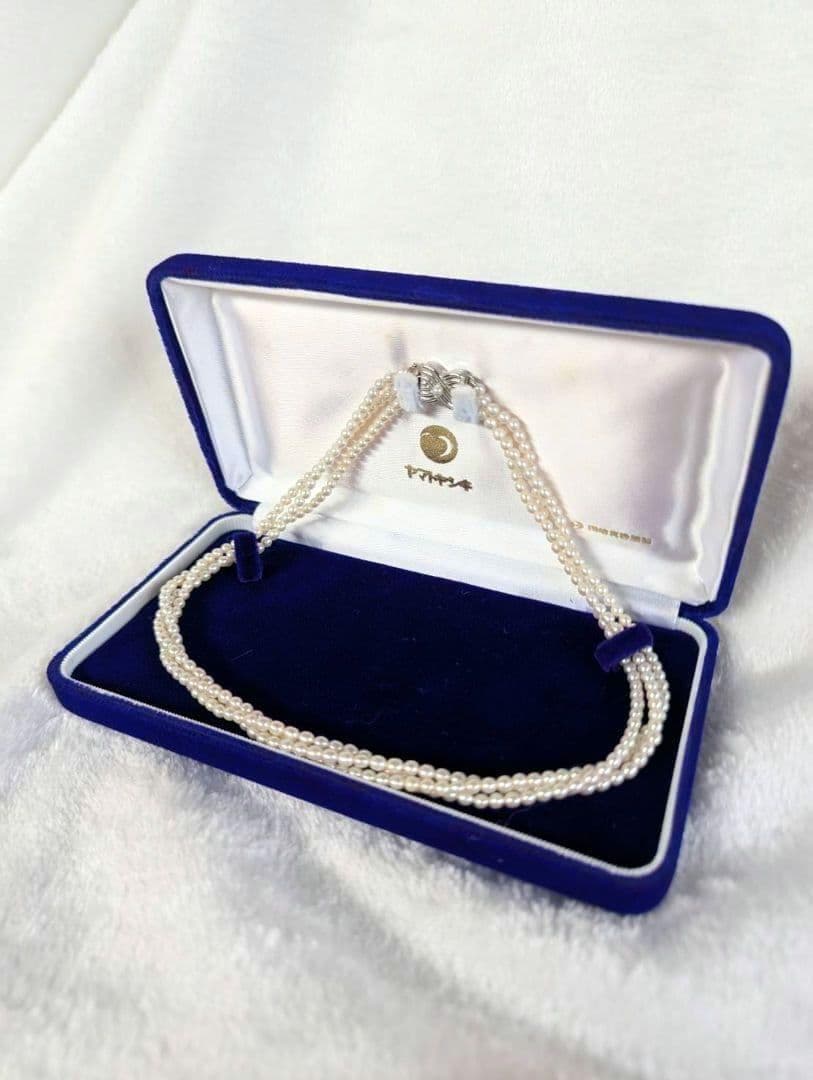 Tazaki Pearl 3-Strand necklace with baby freshwater pearls and silver case on white background