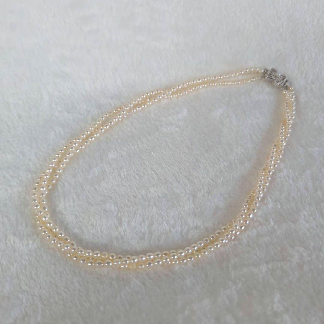Tazaki Pearl 3-Strand necklace with baby freshwater pearls and silver case on white background