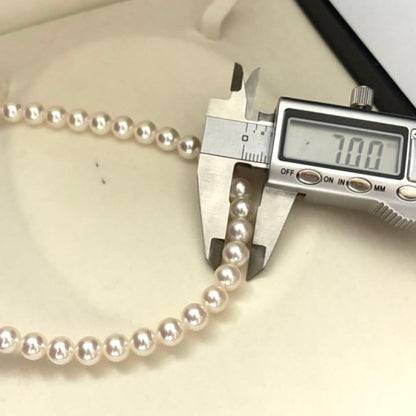 Hanadama Aurora Interference color Akoya pearl necklace in pink white with round 7mm pearls and silver stamp logo