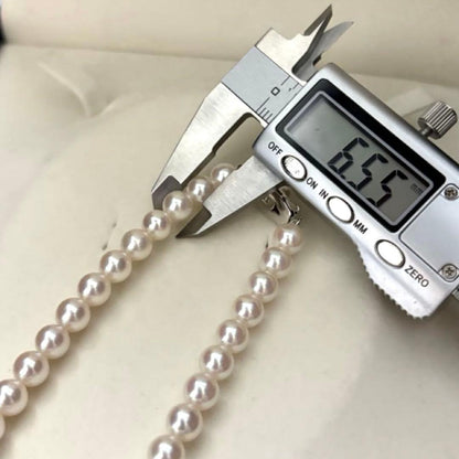 Hanadama Aurora Interference color Akoya pearl necklace in pink white with round 7mm pearls and silver stamp logo