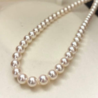 Hanadama Aurora Interference color Akoya pearl necklace in pink white with round 7mm pearls and silver stamp logo