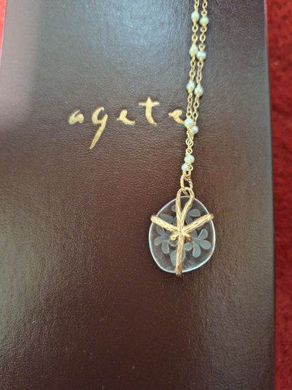 agete flower motif necklace with gold flower pendant and metal chain displayed with dedicated box