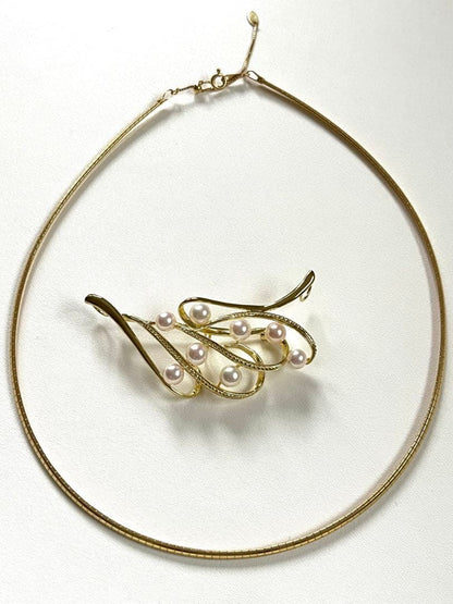 Akoya pearl silver choker necklace with gold color accents and matching brooch measuring 66mm by 30mm