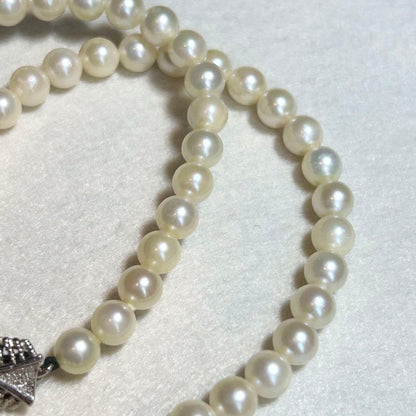 Akoya pearl necklace featuring 7mm to 6.5mm pearls on a 40cm strand with silver stamp