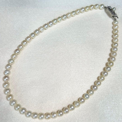 Akoya pearl necklace featuring 7mm to 6.5mm pearls on a 40cm strand with silver stamp