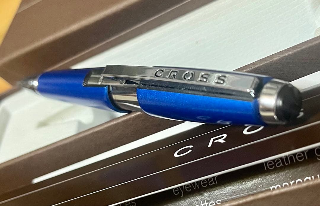 Kuro Cross rollerball pen in blue with included refill, showing a classic design