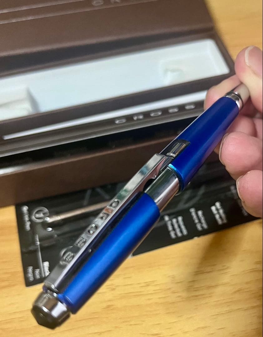 Kuro Cross rollerball pen in blue with included refill, showing a classic design