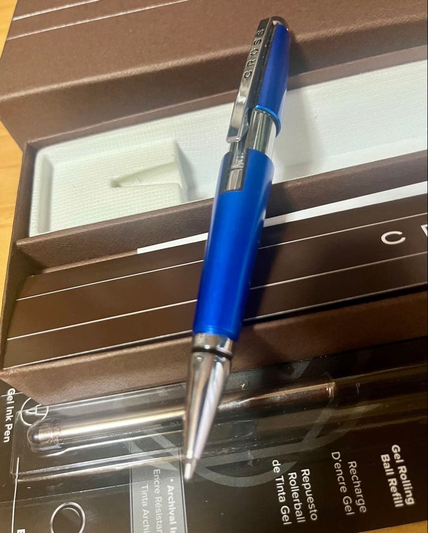 Kuro Cross rollerball pen in blue with included refill, showing a classic design