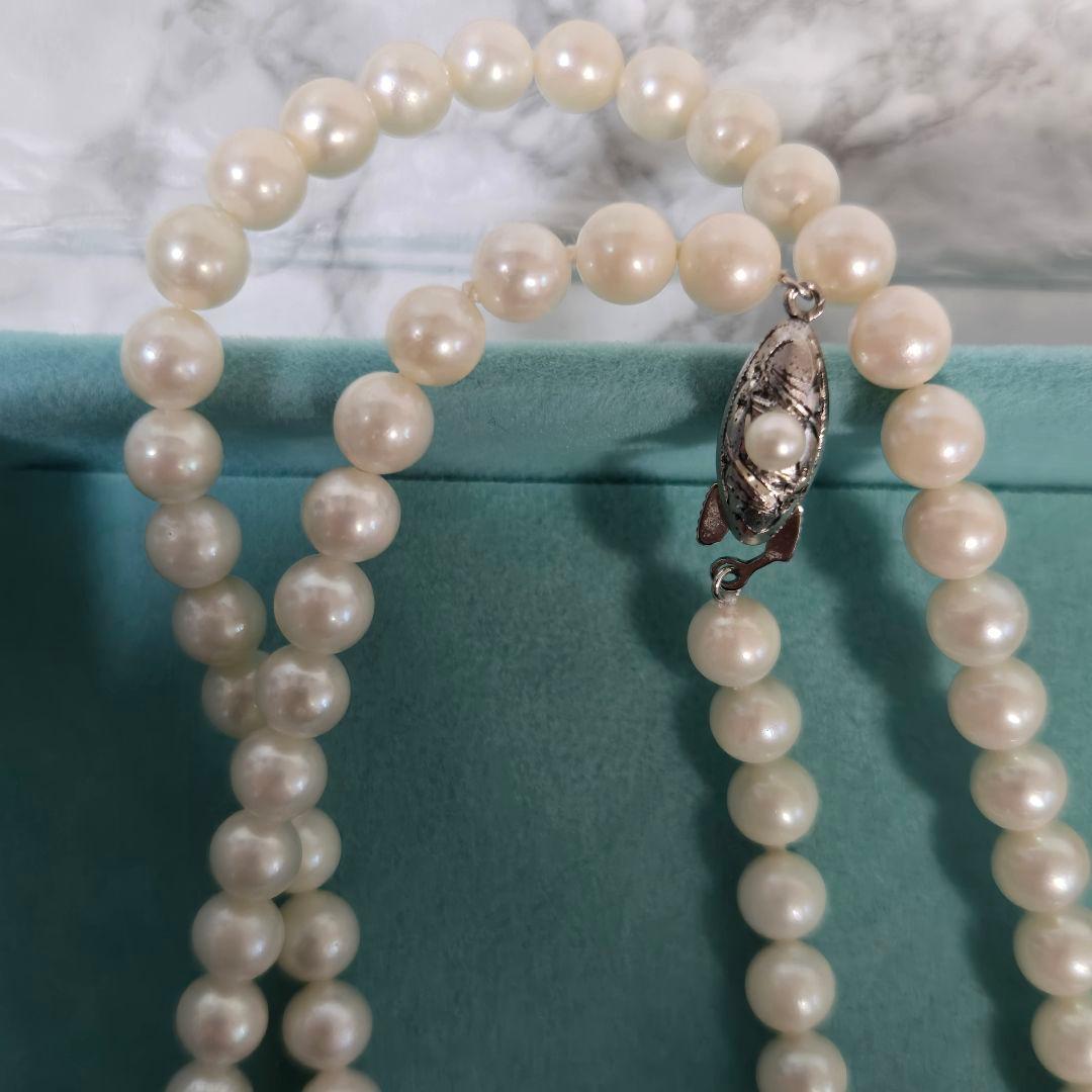 Long Akoya pearl necklace with 6mm genuine pearls on a silver chain measuring 116 cm