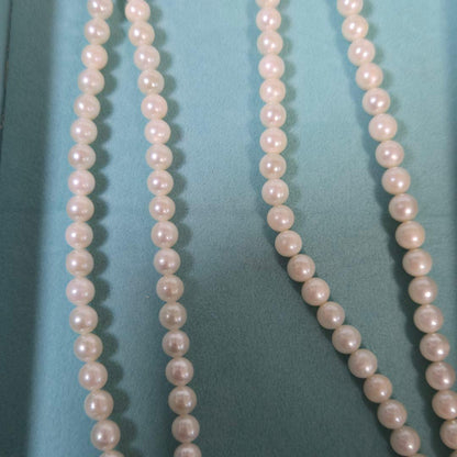 Long Akoya pearl necklace with 6mm genuine pearls on a silver chain measuring 116 cm