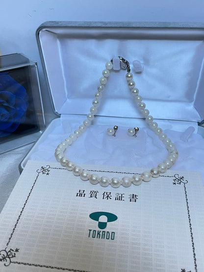 8.5mm Akoya pearl necklace with silver clasp and matching round pearl earrings featuring exposed flesh markings