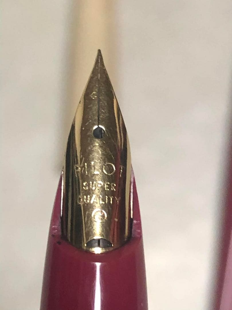 Pilot fountain pen in red color with sleek design and silver clip shown from side view