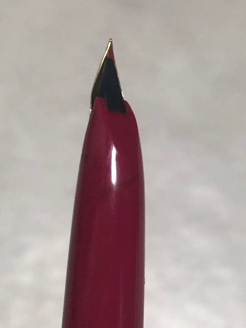 Pilot fountain pen in red color with sleek design and silver clip shown from side view