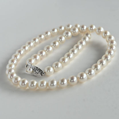 Takatsuki Akoya pearl necklace with 7.0mm round pearls and silver clasp on a white background