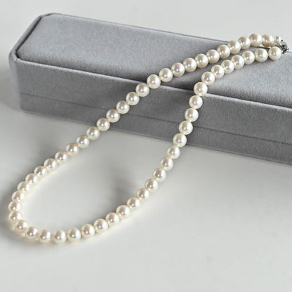 Takatsuki Akoya pearl necklace with 7.0mm round pearls and silver clasp on a white background