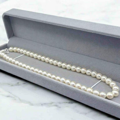 Takatsuki Akoya pearl necklace with 7.0mm round pearls and silver clasp on a white background