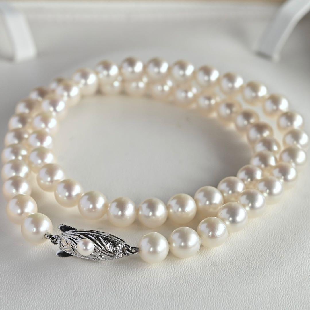Takatsuki Akoya pearl necklace with 7.0mm round pearls and silver clasp on a white background