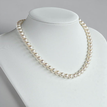 Takatsuki Akoya pearl necklace with 7.0mm round pearls and silver clasp on a white background