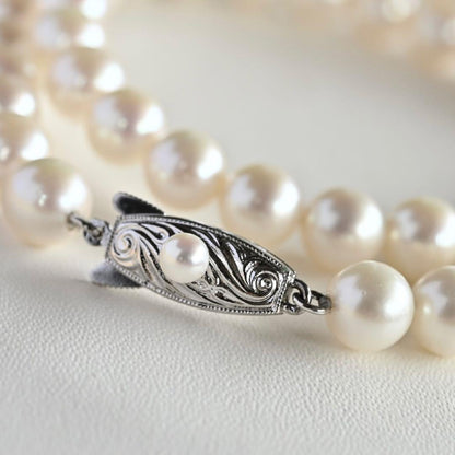 Takatsuki Akoya pearl necklace with 7.0mm round pearls and silver clasp on a white background