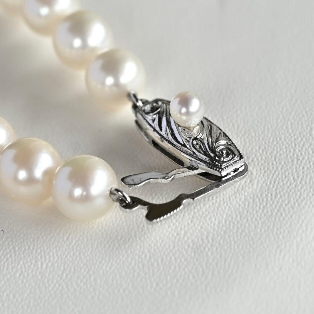 Takatsuki Akoya pearl necklace with 7.0mm round pearls and silver clasp on a white background