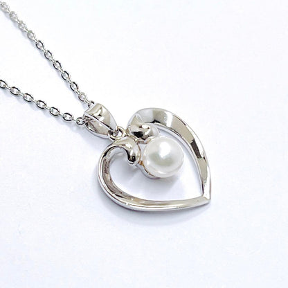 Mikimoto pearl necklace with heart motif featuring 5.4mm pearls on a 46cm silver chain